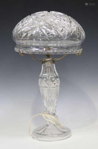 A cut glass table lamp, 20th century, the domed shade above a baluster stem and circular foot, total