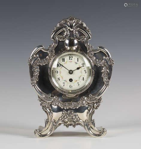 An Edwardian silver cased mantel timepiece, the enamel dial with Arabic numerals and flower