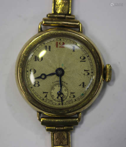 A Longines 9ct gold circular cased lady's wristwatch with a signed jewelled lever movement, the