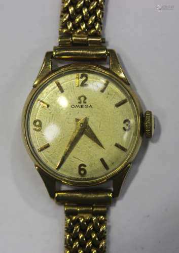 An Omega 9ct gold circular cased lady's bracelet wristwatch, the signed jewelled movement