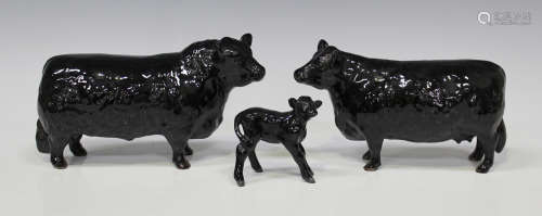 A group of three Beswick models of cows, comprising Aberdeen Angus Bull, No. 1562, Aberdeen Angus