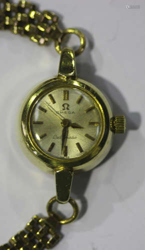 An Omega Ladymatic gilt metal circular cased wristwatch, the signed silvered dial with gilt baton