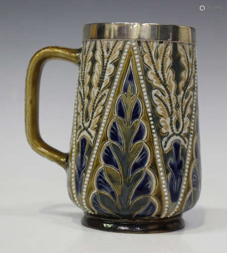 A Doulton Lambeth stoneware silver mounted mug, circa 1878, decorated in relief with alternating