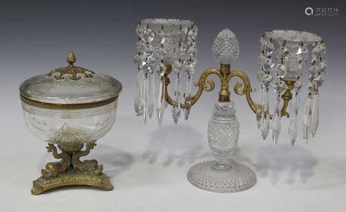 A cut glass and gilt metal mounted twin branch candelabrum, early 20th century, each drip pan hung