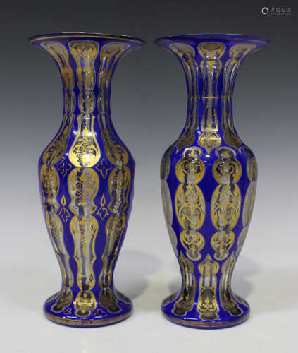 A near pair of Bohemian blue overlay glass vases, late 19th century, of baluster shape, cut with