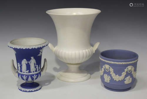 A Wedgwood blue dip jasperware campana urn vase, 19th century, typically ornamented in white with