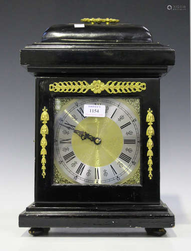 A 20th century Queen Anne style ebonized mantel clock with Smiths movement striking on a gong, the