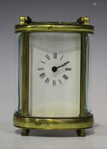 A 20th century French brass oval cased diminutive carriage timepiece, the enamel dial with black