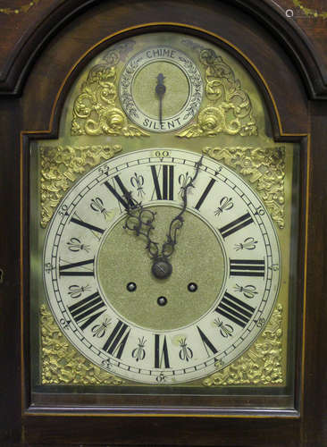 An early 20th century mahogany longcase clock with eight day movement chiming and striking on gongs,