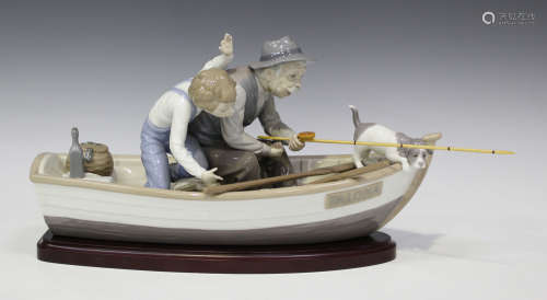 A Lladro porcelain figure group of 'Fishing with Gramps', No. 5215, with wooden stand, length