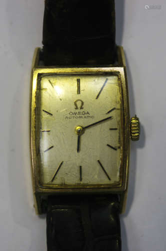 An Omega Automatic 9ct gold curved rectangular cased lady's wristwatch, the signed jewelled circular