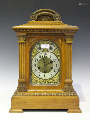 A late 19th/early 20th century German walnut cased mantel clock with eight day movement chiming