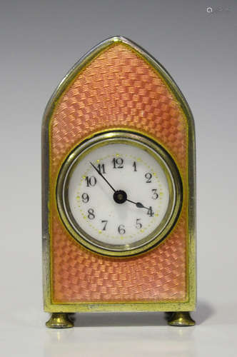 An early 20th century silver gilt and enamel miniature bedside timepiece, the circular enamel dial