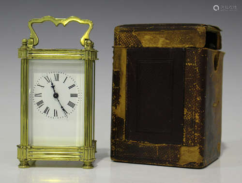 An early 20th century brass cased carriage timepiece with eight day movement, the enamel dial with