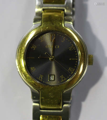 A Gucci steel and gilt lady's bracelet wristwatch, the signed metallic dial with gilt Arabic