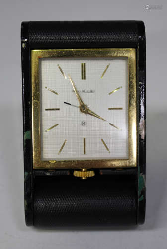 A Jaeger-LeCoultre gilt metal cased travelling alarm clock, the signed silvered dial with gilt baton