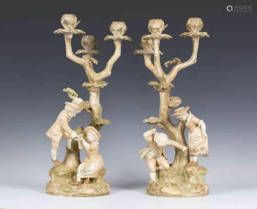 A pair of Royal Worcester porcelain three light candelabra, circa 1887 and 1889, modelled after