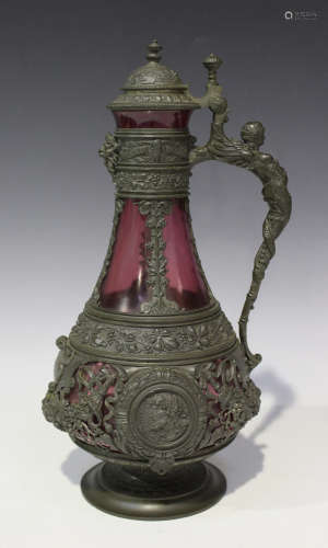 A German pewter mounted cranberry glass claret jug, late 19th century, of low-bellied form, the
