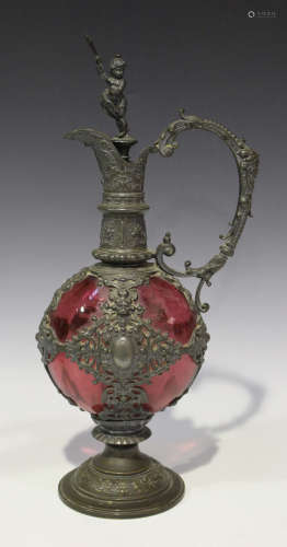 A German pewter mounted cranberry glass claret jug, late 19th century, with baroque style mounts,