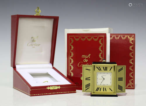 A Must de Cartier gilt metal triptych bedside alarm clock with quartz movement, the reverse detailed