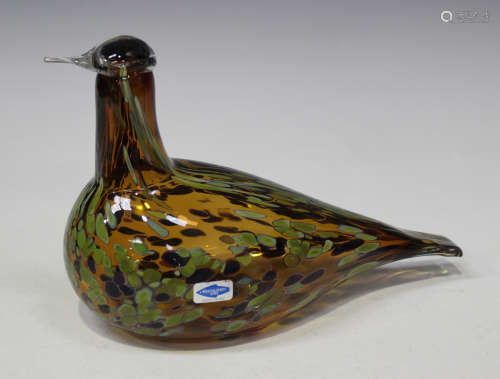A Nuutajärvi glass bird, designed by Oiva Toikka, of clear brown tint with splashed brown and