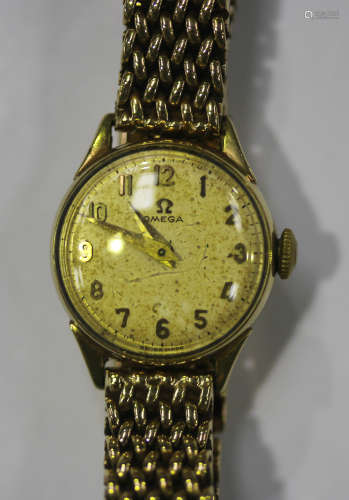 An Omega 9ct gold circular cased lady's wristwatch, the signed dial with Arabic numerals, on a 9ct