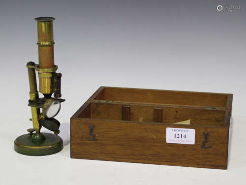 A late Victorian brass student's microscope, fitted with magnifier and mirror, on a circular