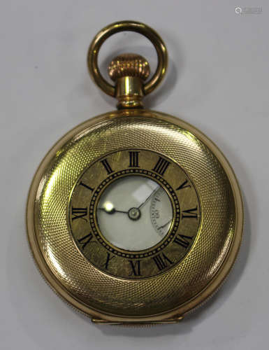 A gilt metal half-hunting cased keyless wind gentleman's pocket watch, the enamel dial with black