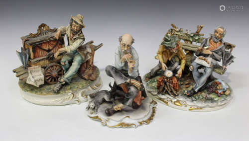 A collection of mostly Capodimonte figures, including two men seated on a bench, three models of