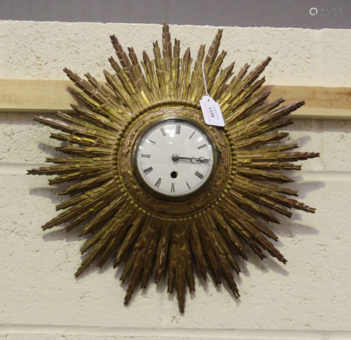 An early 20th century French giltwood sunburst wall timepiece, the enamel dial with Roman hour