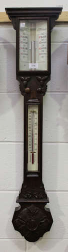 A late Victorian oak stick barometer with alcohol thermometer, the dial with twin angled vernier