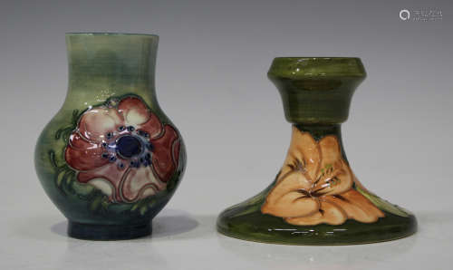 A Moorcroft pottery candlestick, circa 1968-80, decorated with Coral Hibiscus design against a green