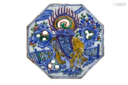 A CHINESE FAMILLE VERTE ‘ELEPHANT’ PLAQUE. Kangxi. Of octagonal form with pierced decoration, painted with an elephant standing in a garden among rock work, the back supporting a lotus flower which supports a flaming pearl, 12cm diameter.