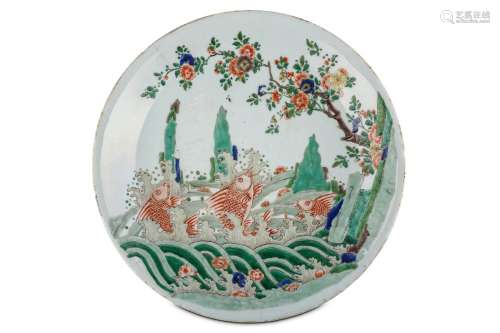A CHINESE FAMILLE VERTE 'JUMPING CARP' CHARGER. Kangxi. Finely painted to the interior with three iron red carp among frothing waves, from which emerge jagged rocks, with a flowering plum tree extending overhead, with fallen flower heads tossed on