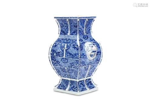 A CHINESE BLUE AND WHITE VASE, FANGHU. Kangxi. Of square section, the spreading foot rising to a baluster body, waisted neck and flared rim, middle section applied on two sides with lion-mask handles and the edges and centres of each side with