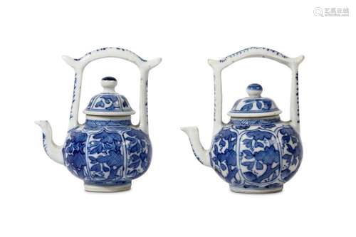 A PAIR OF CHINESE BLUE AND WHITE TEAPOTS AND COVERS. Kangxi. Of globular form, with high domed covers below gate handles, the body of each moulded with floral panels, 10cm H. (4) Provenance: English private collection, acquired from Marchant in the