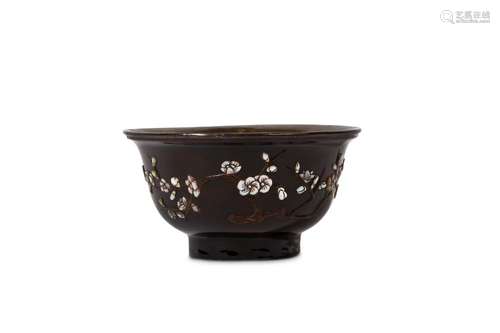 A CHINESE INLAID BLACK LACQUER BOWL. Qing, 18th Century. The rounded sides supported on a tall foot, rising to an everted rim, the exterior inlaid in mother-of-pearl and coconut shell to depict a flowering plum branch opposite a single butterfly in