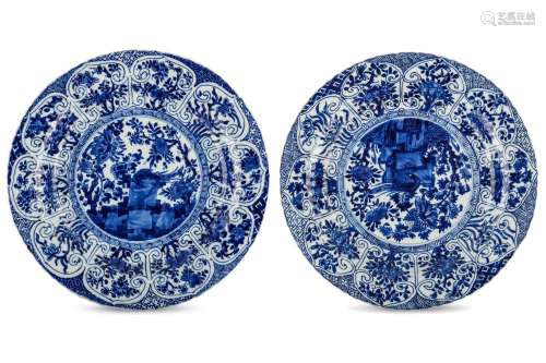A PAIR OF CHINESE BLUE AND WHITE ‘PHOENIX ON ROCK’ DISHES. Kangxi. Each with a central roundel, depicting a phoenix bird squatting on ornamental rock among flowering peonies, within a key scroll border, the ribbed sides with a band of ruyi head