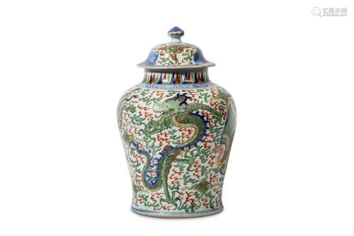 A CHINESE FAMILLE VERTE 'DRAGON AND PHOENIX' JAR AND COVER. 17th Century. Of baluster form, with a domed cover supporting a bud-form finial, decorated with coiled four-clawed dragons alternating with phoenixes all surrounded by among flames below a