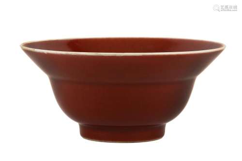 A CHINESE LANGYAO KLAPMUTS BOWL. Kangxi. The rounded body supported on a short high foot and rising to a conical rim, decorated all over with a deep red glaze, the rim with a white band, 9cm H, 21cm diameter. 清康熙   郎窯紅釉折沿盌