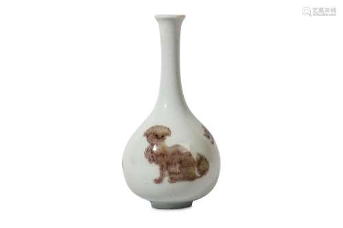 A SMALL CHINESE COPPER RED 'MYTHICAL BEASTS' BOTTLE VASE. Kangxi. Painted around the pear-shaped body with a lion, a pixiu and a bixie, the eyes picked out in underglaze blue, 14cm H. 清康熙   釉里紅三獸紋長頸瓶