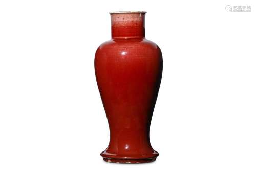A CHINESE LANGYAO BALUSTER VASE. Kangxi. The slender baluster body rising from a spreading foot to a waisted neck and flared rim, covered in a deep copper-red glaze draining to white at the rim, suffused with a network of fine crackle throughout, the
