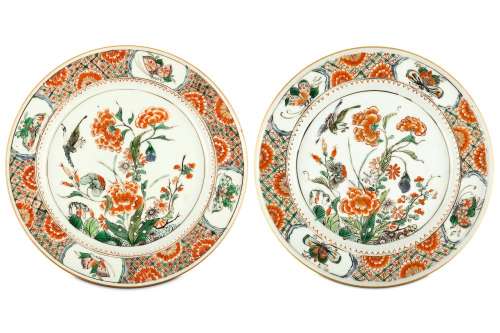 A PAIR OF CHINESE FAMILLE VERTE ‘BIRD AND FLOWER’ DISHES. Kangxi. The central roundel finely enamelled with peonies and other flowering plants with an attendant bird, within a diaper border interspersed with flower heads and with four panels