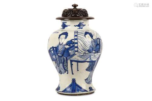 A CHINESE BLUE AND WHITE ‘SEAMSTRESSES’ VASE. Kangxi. Of baluster form, finely painted in underglaze blue with group of well four dressed ladies, one seated  cutting fabric with a companion sewing around a dreamstone-inset table in front of a