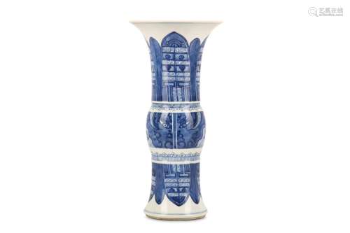 A SMALL CHINESE BLUE AND WHITE BEAKER VASE, GU. Kangxi. Decorated with archaistic taotie masks to the mid-section and lappets to the flaring base and neck, 36cm H, 17.5cm diameter. 清康熙   青花饕餮紋觚式瓶 For blue and white vases with