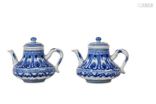 A PAIR OF CHINESE MINIATURE TEAPOTS AND COVERS. Kangxi. Of pear-shaped form with eared handles and curving spouts, decorated with classic scrolls and pendant petal-panels containing floral motifs, along with both pendant and upright leaf forms, 7cm