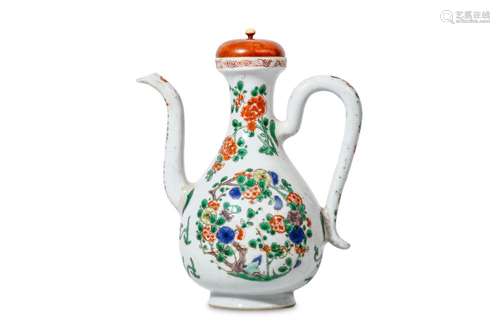 A CHINESE FAMILLE VERTE EWER. Kangxi. The pear-shaped body with a high S-shaped spout opposite a loop handle, the body enamelled on either side with a roundel composed of a flowering plum tree, with attendant floral bouquets to the neck, wood cover,