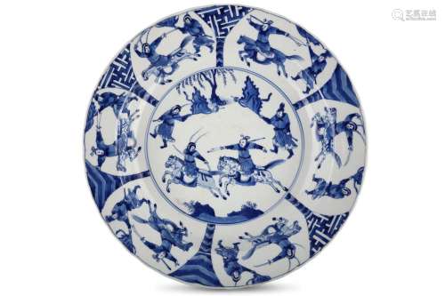 A CHINESE BLUE AND WHITE ‘WARRIORS’ BASIN DISH. Kangxi. The central roundel with warriors on horseback beside two further figures on foot holding flags, within a band of six panels each enclosing a warrior on horseback beside a flag-bearing