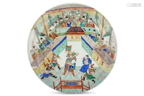 A LARGE CHINESE FAMILLE VERTE CHARGER. Kangxi. Depicting three clans vying for power with representatives seated along three tables each laid with antique treasures, a fearsome warrior standing in the foreground holding a bronze vessel high above his