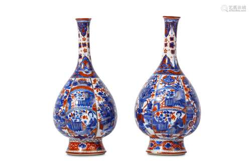 A PAIR OF CHINESE IMARI-DECORATED VASES. Kangxi. Of pear-shaped form with spreading foot and tall waisted neck, the body decorated with panels, of antiques alternating with panels sub-divided into antiques, ladies and garden scenes, the neck with